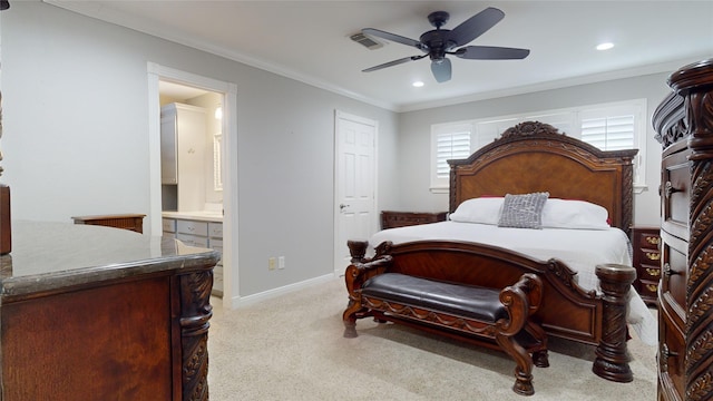 bedroom featuring ornamental molding, light colored carpet, ceiling fan, and ensuite bath