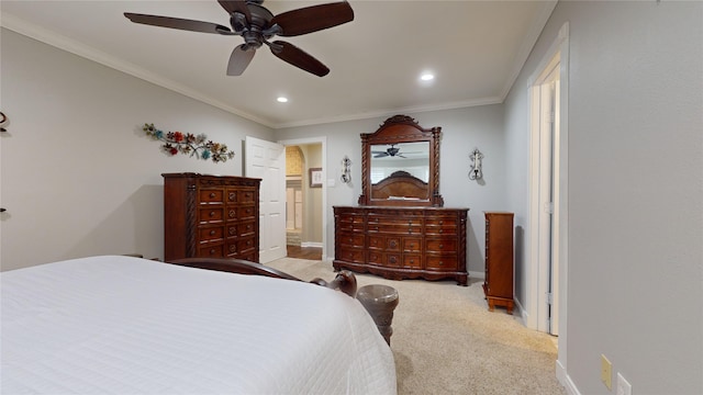 carpeted bedroom featuring ensuite bathroom, ceiling fan, and crown molding