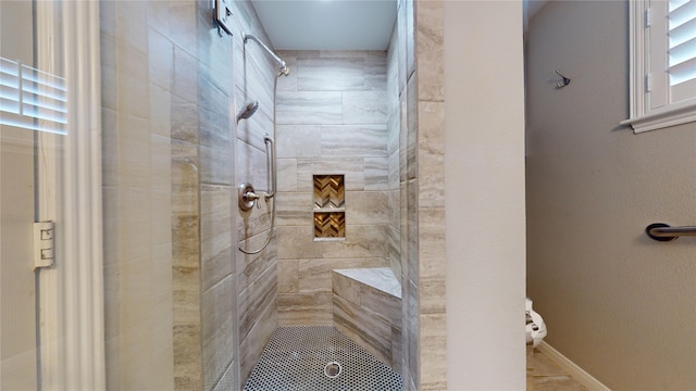 bathroom with tiled shower