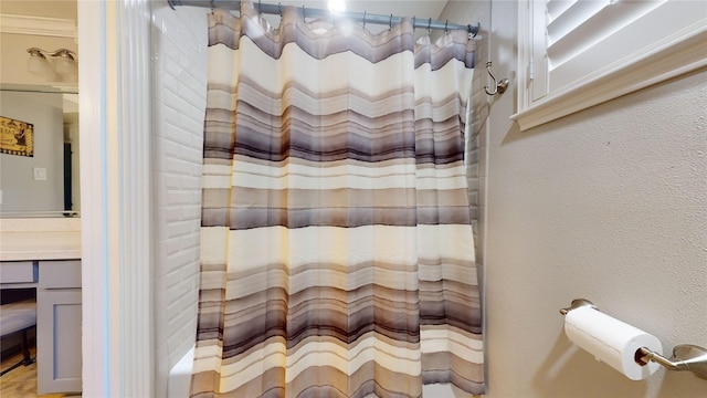 bathroom featuring walk in shower and vanity