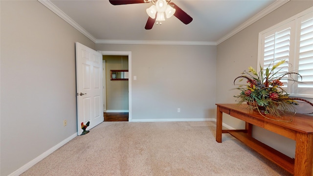 interior space featuring ceiling fan, light carpet, and ornamental molding