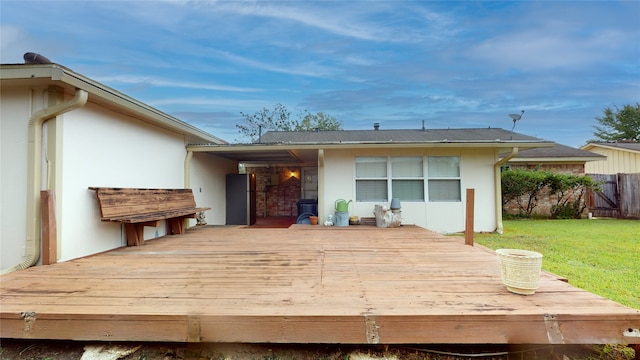 back of property featuring a yard and a deck