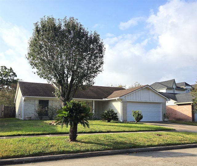 single story home featuring a front lawn and a garage