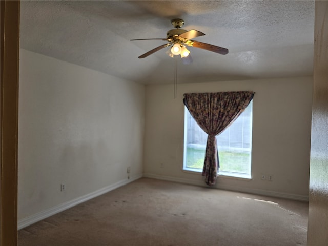 carpeted empty room with a textured ceiling and ceiling fan