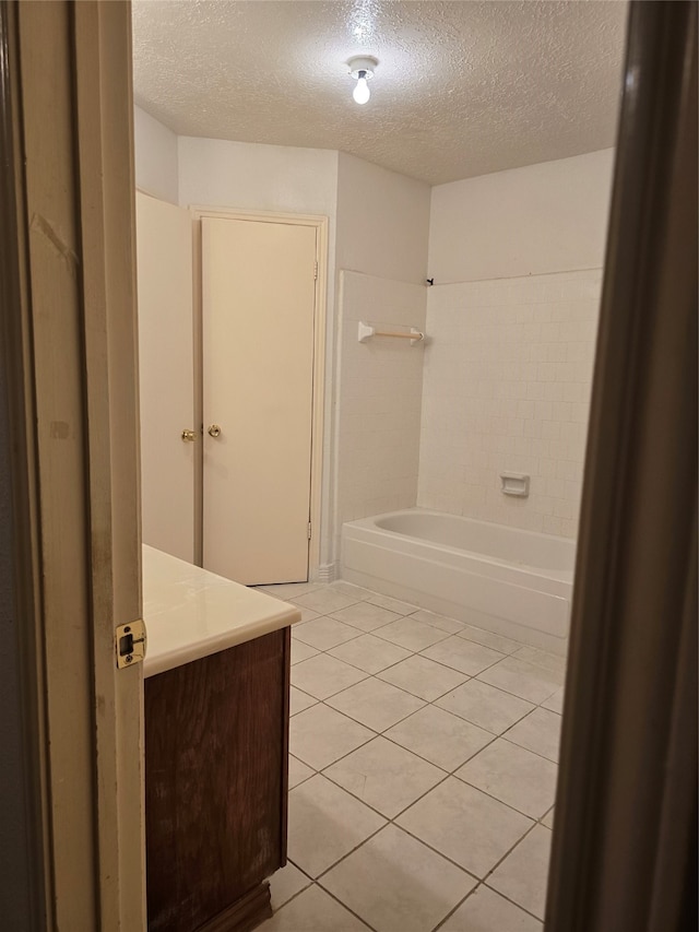 bathroom featuring vanity, a textured ceiling, and tile patterned flooring