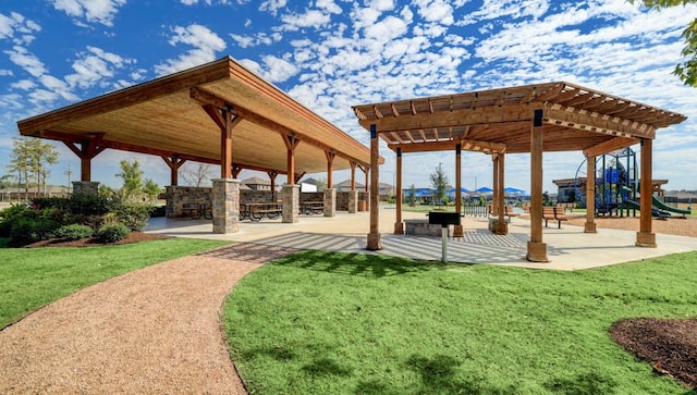 view of home's community with a lawn, a playground, and exterior bar