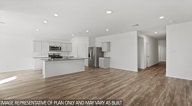 kitchen with white cabinets, a kitchen island with sink, appliances with stainless steel finishes, and light hardwood / wood-style flooring