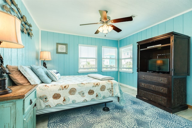 bedroom featuring ceiling fan, light hardwood / wood-style flooring, and crown molding