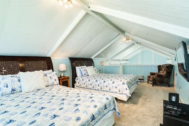 bedroom featuring wooden walls, light carpet, and vaulted ceiling with beams