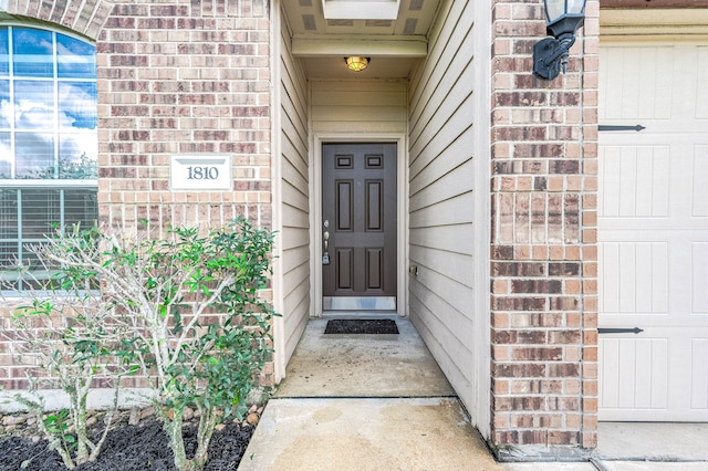 view of exterior entry with a garage