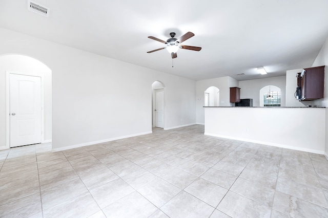 unfurnished living room featuring light tile patterned floors and ceiling fan