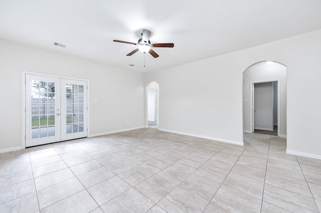 unfurnished room with french doors, light tile patterned floors, and ceiling fan