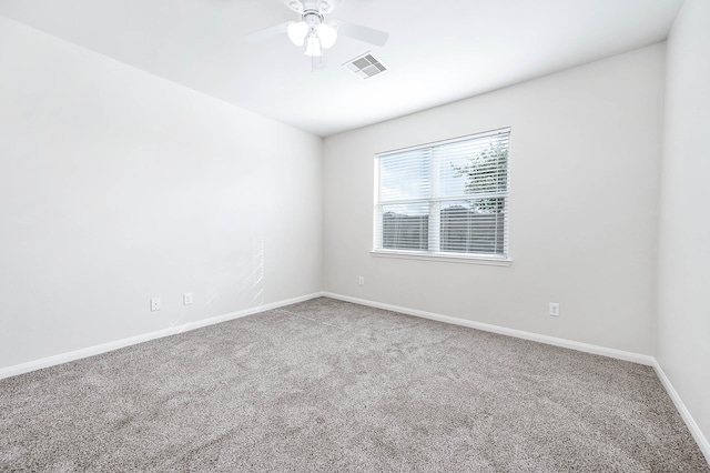 spare room featuring ceiling fan and carpet floors