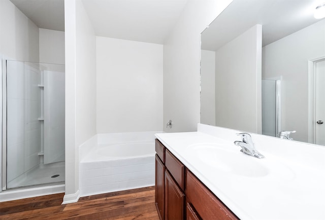 bathroom featuring shower with separate bathtub, wood-type flooring, and vanity