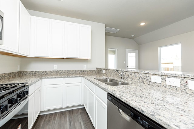 kitchen with sink, vaulted ceiling, dark hardwood / wood-style flooring, white cabinetry, and stainless steel appliances