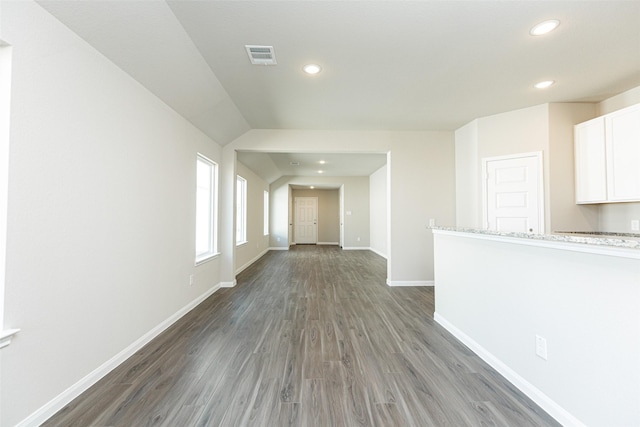 unfurnished living room with dark wood-type flooring