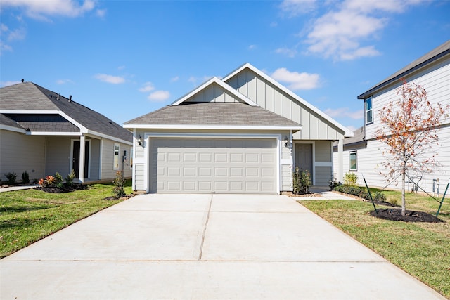 view of front of property with a front yard and a garage