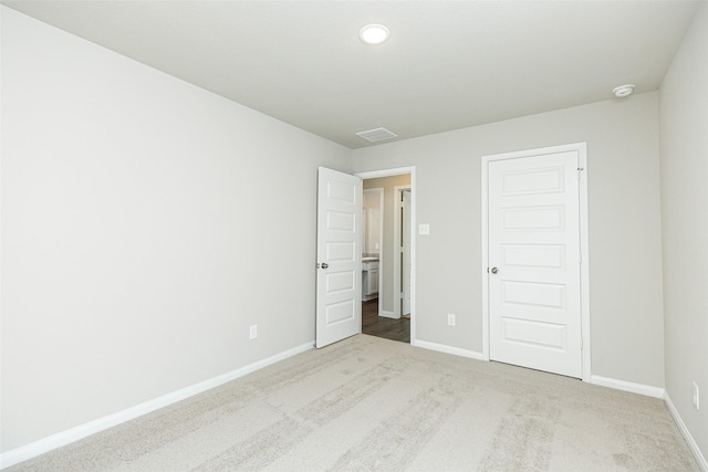 unfurnished bedroom featuring carpet flooring and a closet