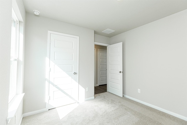 unfurnished bedroom featuring light colored carpet