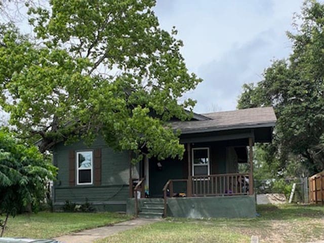 bungalow-style house with a porch and a front lawn