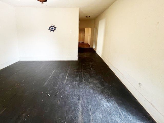 unfurnished room with dark hardwood / wood-style floors