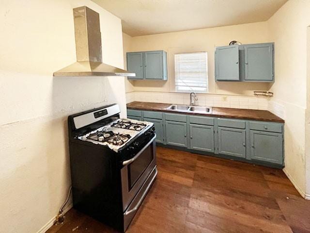 2251 Burnet St, San Antonio, TX 78202 - kitchen featuring stainless steel range with gas stovetop, a sink, wall chimney range hood, dark wood-style flooring, and tasteful backsplash