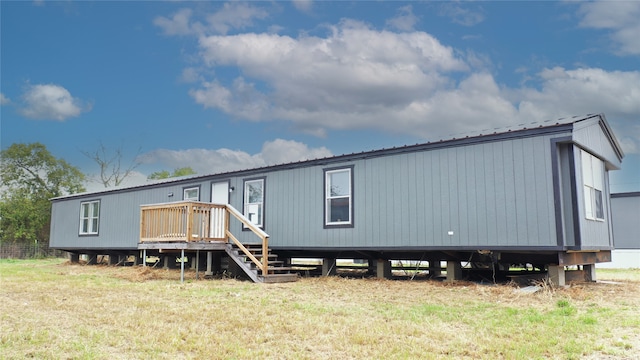 back of house featuring a yard and a deck