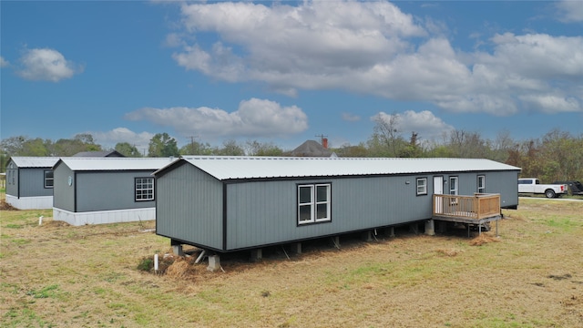 back of house with a lawn