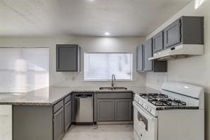 kitchen featuring gray cabinets, white range with gas stovetop, sink, stainless steel dishwasher, and kitchen peninsula