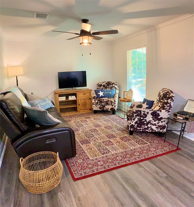 living room with ceiling fan, hardwood / wood-style flooring, and ornamental molding