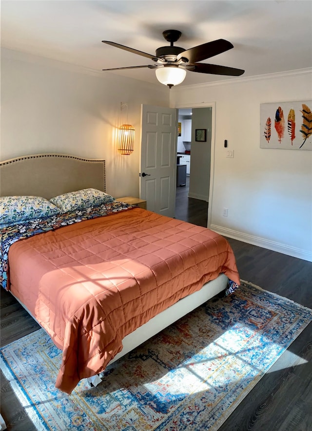 bedroom featuring dark hardwood / wood-style flooring, ceiling fan, and crown molding