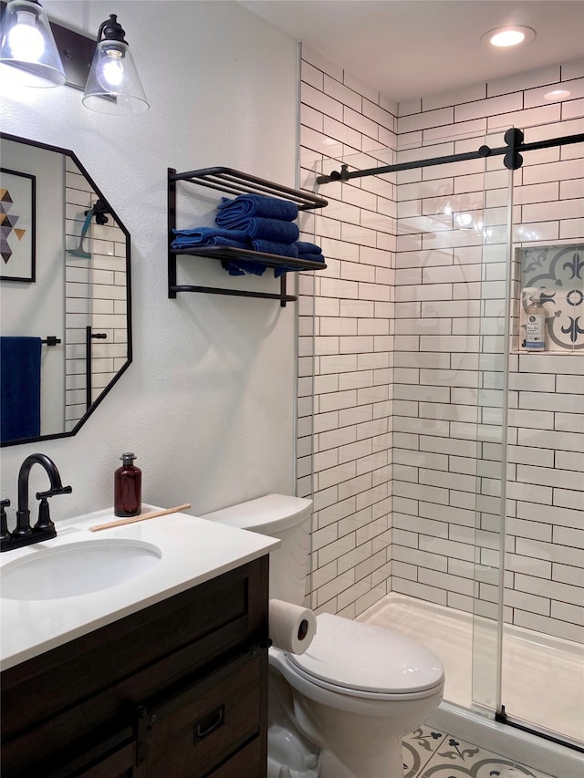 bathroom with toilet, vanity, and an enclosed shower