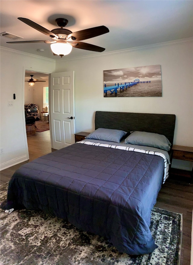 bedroom featuring ornamental molding, wood-type flooring, and ceiling fan