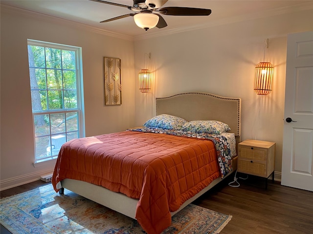 bedroom with crown molding, dark hardwood / wood-style floors, and ceiling fan