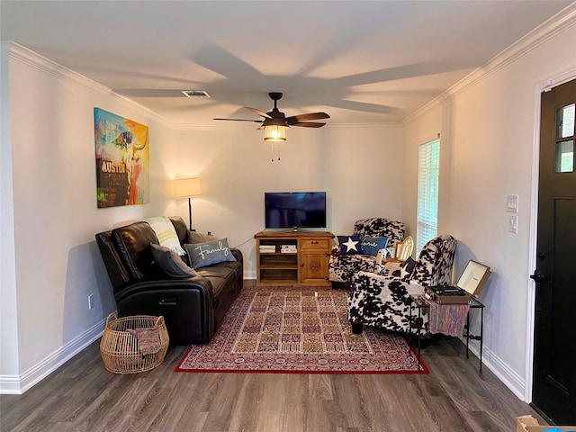 living room with dark wood-type flooring, ceiling fan, and crown molding