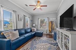 living room featuring hardwood / wood-style flooring, ceiling fan, and ornamental molding