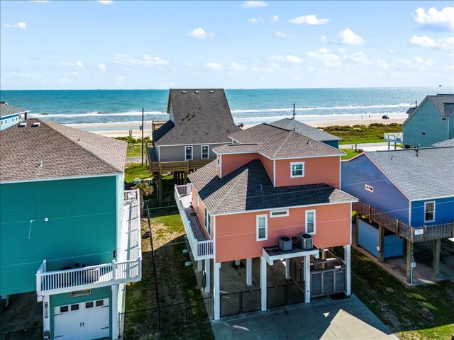 aerial view with a water view and a beach view