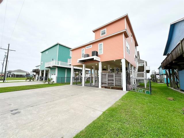 view of front of property with a carport and a front lawn