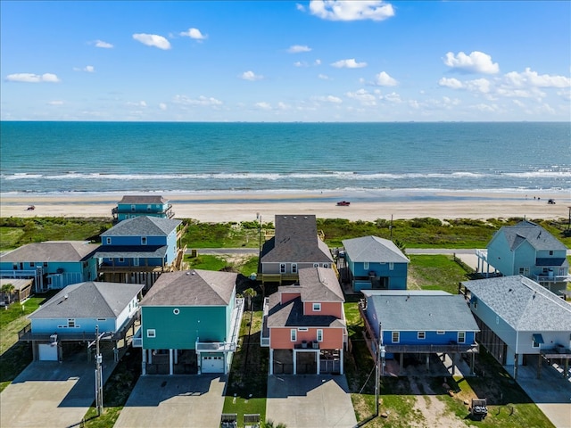 bird's eye view featuring a water view and a beach view