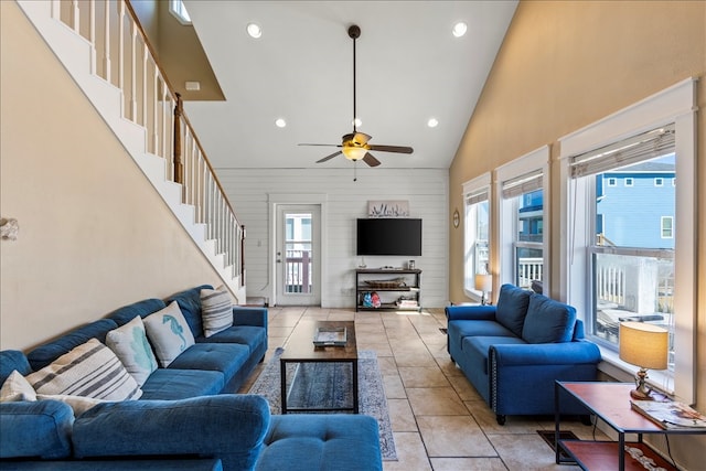 living room featuring a wealth of natural light, high vaulted ceiling, and light tile patterned floors