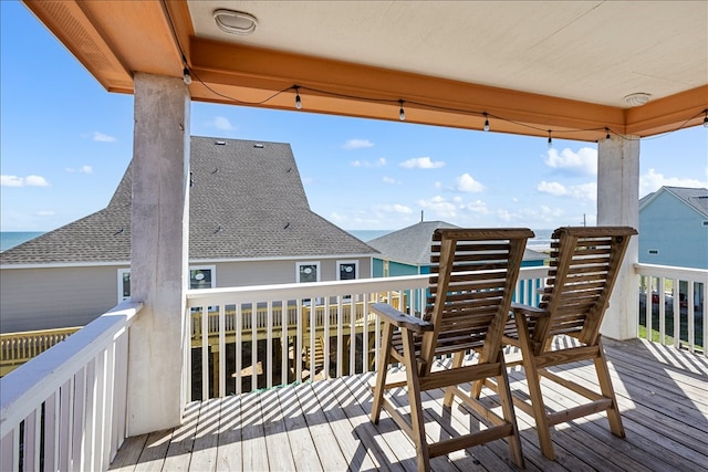 wooden terrace featuring a water view