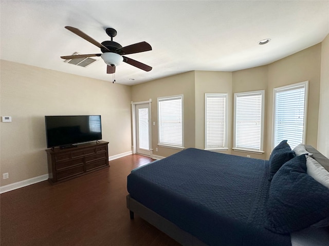 bedroom with ceiling fan, dark hardwood / wood-style flooring, and multiple windows