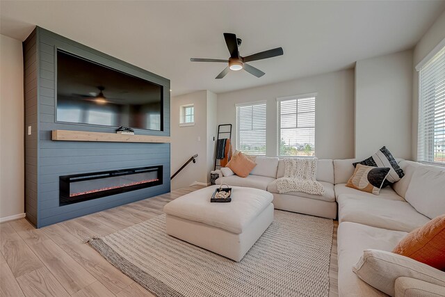 7659 Green Bulrush Way, Katy, TX 77493 - living area featuring wood finished floors, a fireplace, a ceiling fan, and baseboards