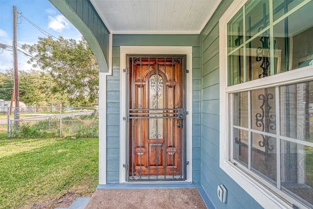 doorway to property featuring a yard