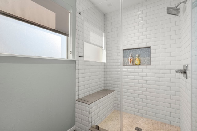 bathroom featuring a shower with shower door