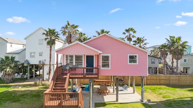 back of house featuring a patio, a yard, and a deck