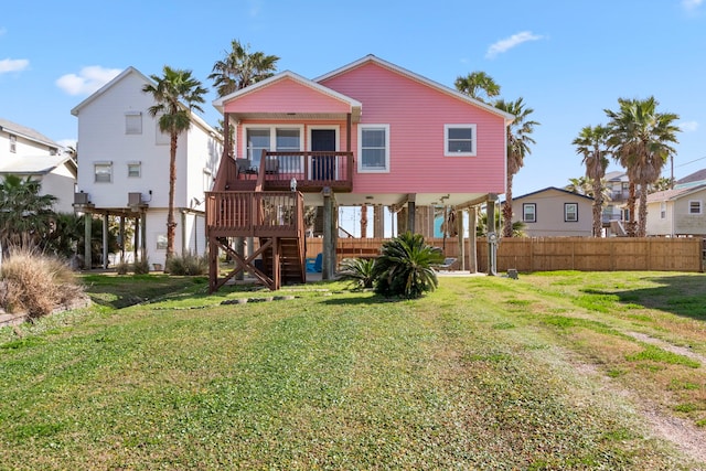 back of house with a lawn and a wooden deck