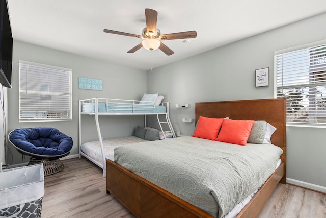 bedroom with ceiling fan and light hardwood / wood-style flooring