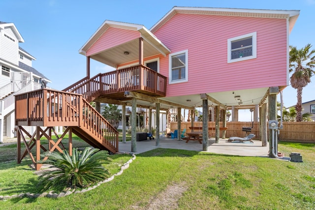 back of house featuring a patio area, a yard, and a deck