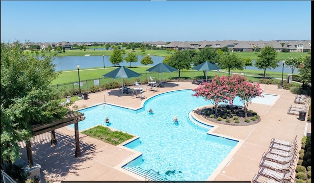 view of swimming pool with a water view and a patio